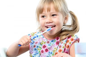 Small girl brushing her teeth