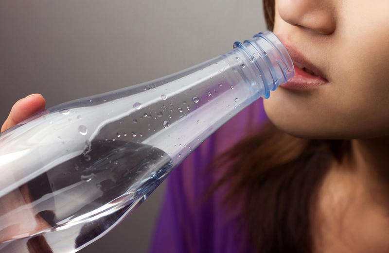 Woman drinking water from water bottle