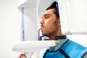 Male dental patient having panoramic x-ray taken of mouth
