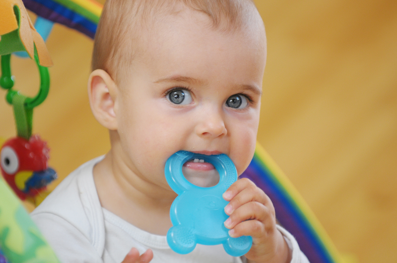 Baby chewing on a teething toy