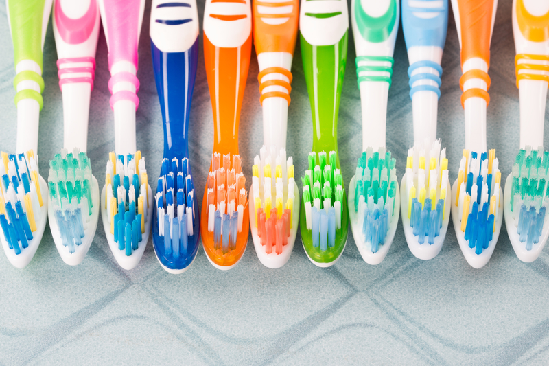 Image of many different colors and sizes of toothbrushes