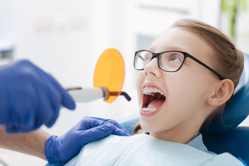 Patient with braces receiving dental help