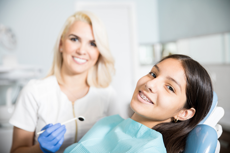 Young girl with braces at an orthodontic appointment to have her braces adjusted.